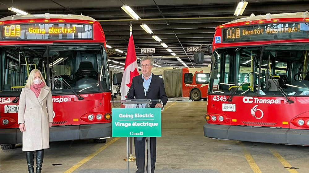 Ottawa Mayor Jim Watson, along with Canada's Minister of Infrastructure and Communities, at an event in March 2021 announcing the federal government's commitment to help transit agencies transition to zero - emission fleets.  The city's Transit Commission has approved a plan that would eventually deliver 450 zero-emission buses to OC Transpo by 2027.