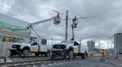 Crews work on the wiring system above the LRT tracks.