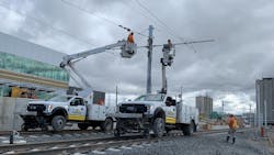 Crews work on the wiring system above the LRT tracks. Crews work on the wiring system above the LRT tracks.