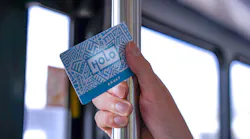 An adult HOLO card in a rider's hand.