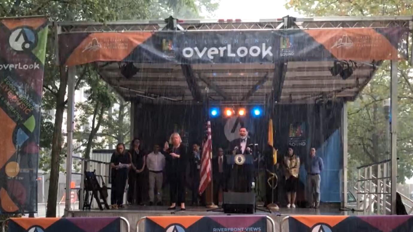 Pittsburgh Mayor William Peduto speaks during a press conference announcing MovePGH and Universal Basic Mobility programs; part of the announcement occurred during a downpour.