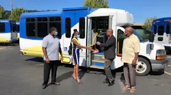 TriMet General Manager Sam Desue, Jr. hands keys to Pat Daniels, executive director of Constructing Hope.