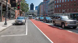 A Route 111 bus travels along North Washington Street opposite Medford Street after construction of a northbound bus lane in July 2021.