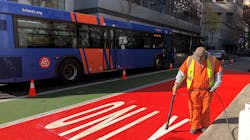 PBOT crews apply red paint to a bus-only lane on SW Main Street. PBOT crews apply red paint to a bus-only lane on SW Main Street.