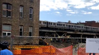 A CTA train is seen traveling behind the Vautravers building, which is being moved 30 feet to the west so CTA can straighten a curve in the track.