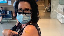 Anne Marie Aikins, head of media and public relations, proudly shows proof of her COVID-19 jab. Anne Marie Aikins, head of media and public relations, proudly shows proof of her COVID-19 jab.