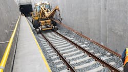 In this July 2021 photo, crews lay third rail by the track for the yard lead tunnel approach structure in Harold Interlocking. In this July 2021 photo, crews lay third rail by the track for the yard lead tunnel approach structure in Harold Interlocking.