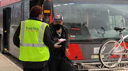 A member of the CapMetro team handing out safety care packages to riders.