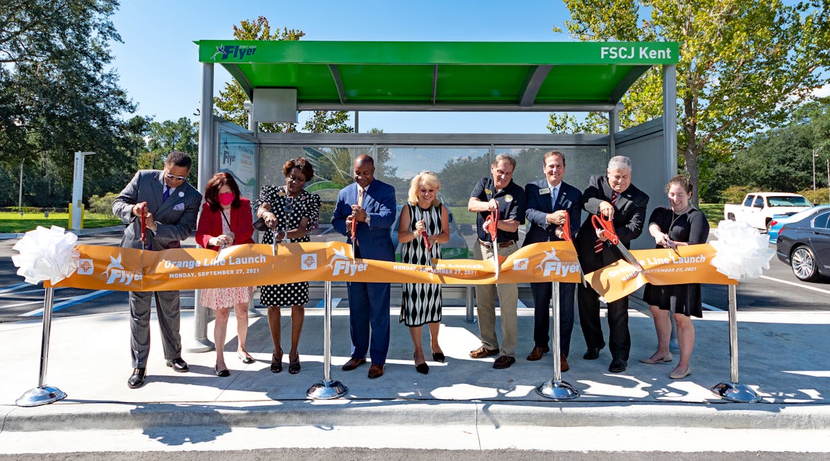 Officials cut the ribbon at a bus stop to mark the opening of JTA&apos;s First Coast Flyer Orange Line.