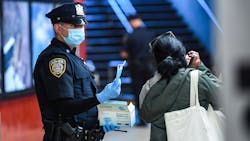 An MTA Police Officer distributes masks to MTA riders on Sept. 22; the authority plans to step up efforts to enforce proper mask wearing among riders. An MTA Police Officer distributes masks to MTA riders on Sept. 22; the authority plans to step up efforts to enforce proper mask wearing among riders.