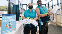 Sound Transit representatives hand out masks to riders in September 2020.