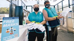 Sound Transit representatives hand out masks to riders in September 2020. Sound Transit representatives hand out masks to riders in September 2020.