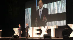 APTA CEO Paul Skoutelas, left and on screen, and APTA Chair Jeff Nelson speak during the opening session of APTA TRANSform Conference and EXPO on Nov. 8.