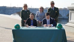 Secretary of the Interior Deb Haaland, left, and Secretary of Transportation Pete Buttigieg sign an MOU focused on improving access and enhancing the transportation experience at National Park Service-managed sites.