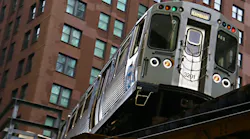 A CTA Brown Line train to Kimball travels on elevated tracks in downtown Chicago.