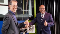 General Manager Sam Desue Jr. and Oregon State Sen. Michael Dembrow give a thumbs up after fueling a TriMet bus with renewable diesel.