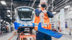 Art Wittich, a SkyTrain vehicle technologist, shows the hockey stick used to clear ice from doors during the winter season.