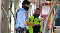 An MTS transit security officer in bright yellow and an Inter-Con security contract officer in blue on a joint patrol.