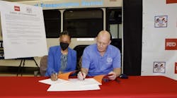 RTD General Manager and CEO Debra A. Johnson, left, and ATU 1001 President and Business Agent Lance Longenbohn sign a new three-year CBA between RTD and ATU 1001 on March 18.