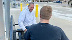 A Chestnut Health employee interacts with a rider on the St. Louis Metro transit system.