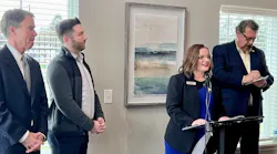 Officials announce the funding match at an event.