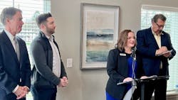 Officials announce the funding match at an event. Officials announce the funding match at an event.