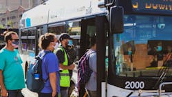 Riders board an EMBARK bus in June 2021. [photo credit: EMBARK]