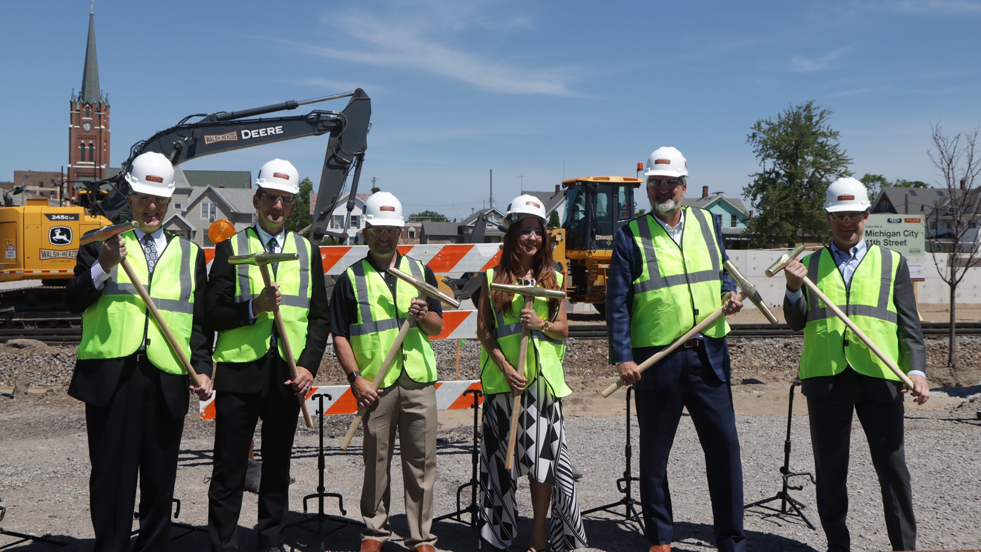 Officials used spike mauls to drive gold spikes into ties to mark the start of construction of the South Shore Double Track NWI project on June 21.