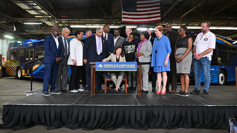 New York Gov. Kathy Hochul, joined by Lieutenant Governor Antonio Delgado, MTA Chairman and CEO Janno Lieber, Senator Leroy Comrie, Assemblymember Vivian Cook and ATU Local 1056 President Mark Henry, signs the Transit Workers Assault Bill at the Queens Bus Terminal in Jamaica on June 27, 2022. This new law protects more than 11,000 MTA workers and prosecutes those who attack transit workers with sentences up to seven years in prison. (Kevin P. Coughlin / Office of Governor Kathy Hochul)