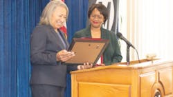 TSA Assistant Administrator Sonya Proctor gives the Golden Standard Award to L.A. Metro CEO Stephanie N. Wiggins.