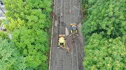 Crews use heavy equipment to make repairs to the MetroLink trackbed that was damaged by historic rains at the end of July.