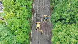 Crews use heavy equipment to make repairs to the MetroLink trackbed that was damaged by historic rains at the end of July.