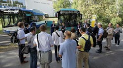 InnoTrans 2018 attendees view buses while on a tour of the expo.