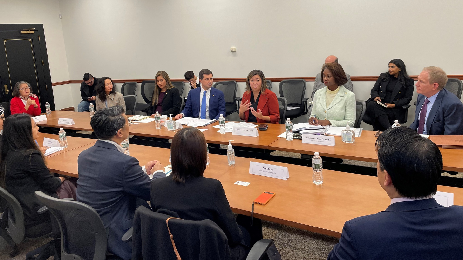 U.S. Rep. Grace Meng (center, red jacket), speaks during a roundtable with U.S. Transportation Secretary Pete Buttigieg, FTA Administrator Nuria Fernandez, MTA Chair and CEO Janno Lieber and representatives of AA & NHPI community organizations.