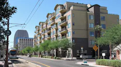 Valley Metro light rail operates in Phoenix, Arz., near a development on Central Ave.