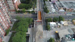 Looking north over Bloor Street West with new west span of the rail bridge constructed.