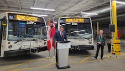 Barrie Mayor Alex Nuttall speaks during an event to mark joint funding that will support the development of an electric bus pilot program in the city. Standing to the right is MP Tony Van Bynen.