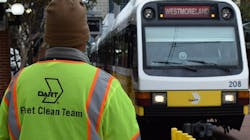 The back of a DART Clean Team uniform employee as they look at a bus The back of a DART Clean Team uniform employee as they look at a bus