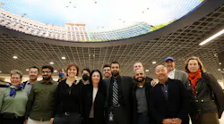The team behind the Powell St. Modernization Program poses for a photo under “Elysium” by Stephen Galloway on Nov. 22, 2022.