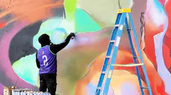 An artist working on one of the murals.