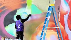 An artist working on one of the murals. An artist working on one of the murals.