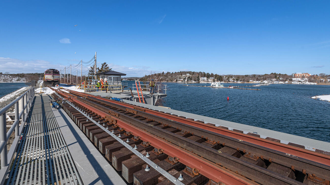 Top deck of the south bascule spans over the channel. Workers have installed new railroad ties and track on the bridge.