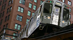 A CTA Brown Line train to Kimball travels on elevated tracks in downtown Chicago.