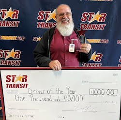Brock Vawter receiving his $1,000 check for the Star Transit 2022 Driver of the Year.