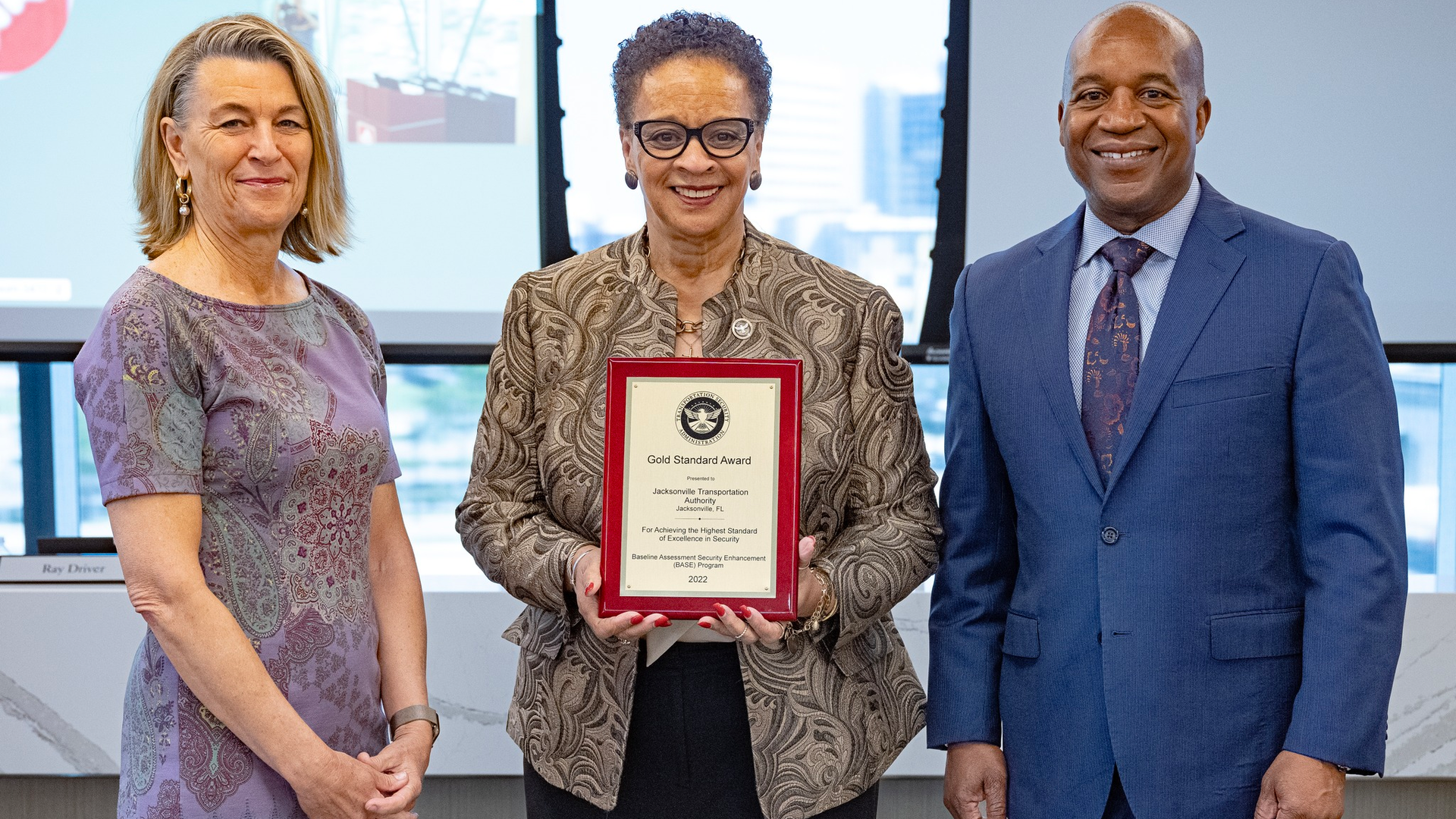 TSA Regional Security Director for Surface Operations Mary V. Leftridge Byrd, center, presents the TSA Gold Standard Award to JTA Chair Debbie Buckland, left, JTA CEO Nathaniel P. Ford at the JTA's March 30 board meeting.
