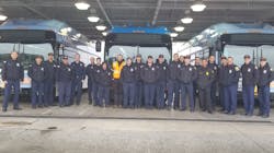 Firefighters pose with OCTA buses during a training on Feb. 24, 2023, to help ensure they can safely respond to incidents involving a bus.