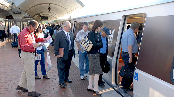 Passengers board a Metrorail Orange Line train.