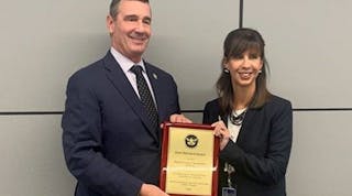TSA Administrator David Pekoske, left, presents a plaque to NFTA Executive Director Kim Minkel indicating that NFTA received the Gold Standard Award.