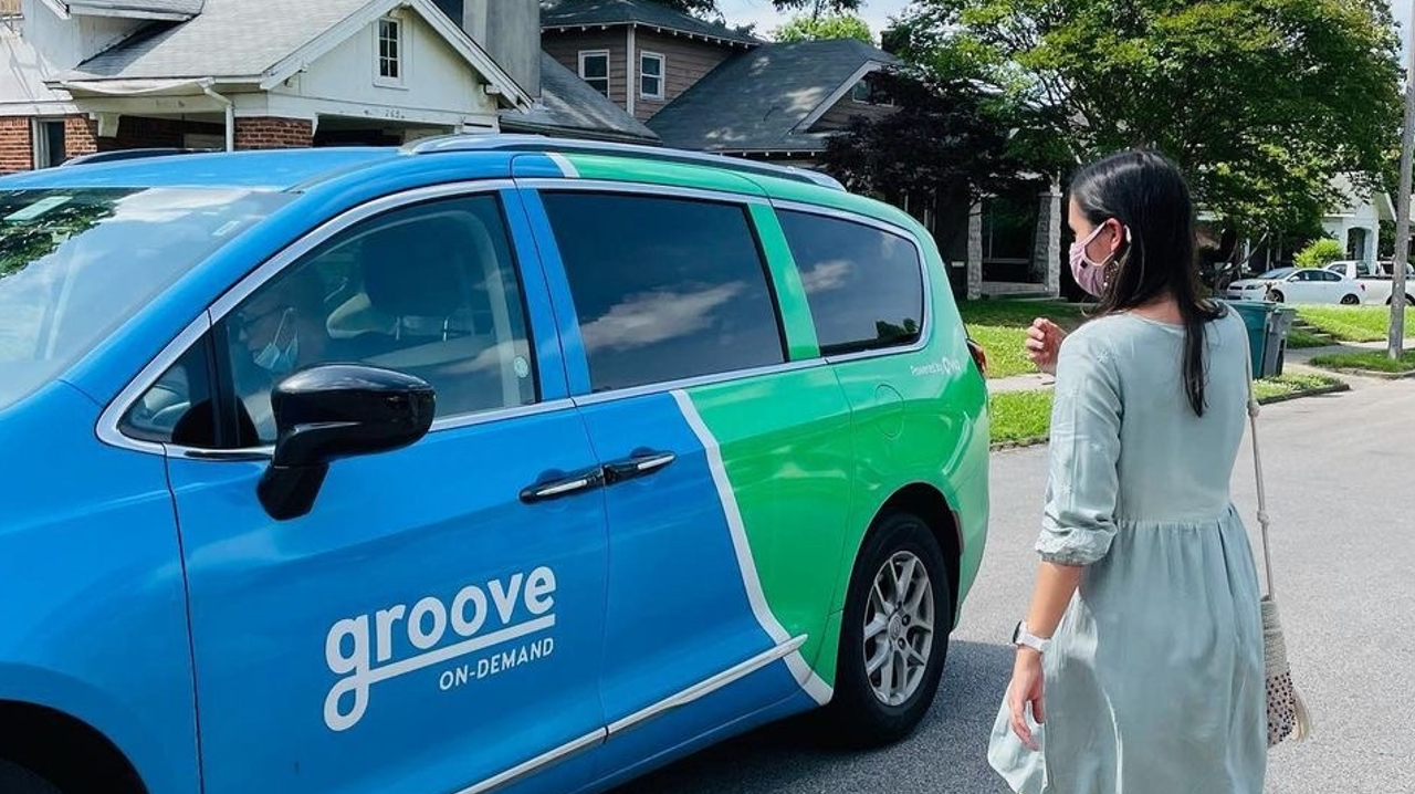 A women walking towards a Groove On-Demand vehicle.