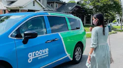 A women walking towards a Groove On-Demand vehicle.